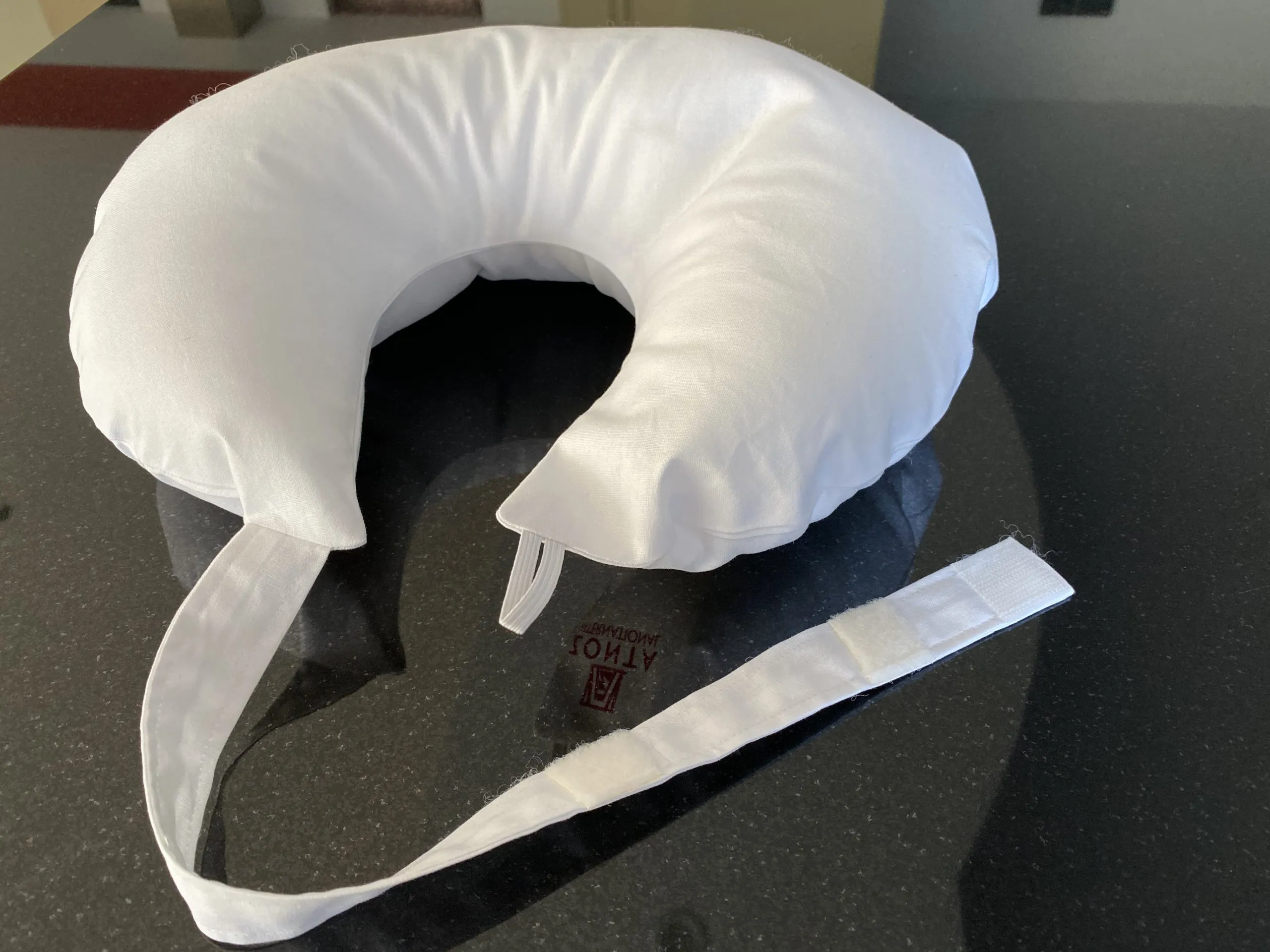 A Zonta breast care cushion with its adjustable strap