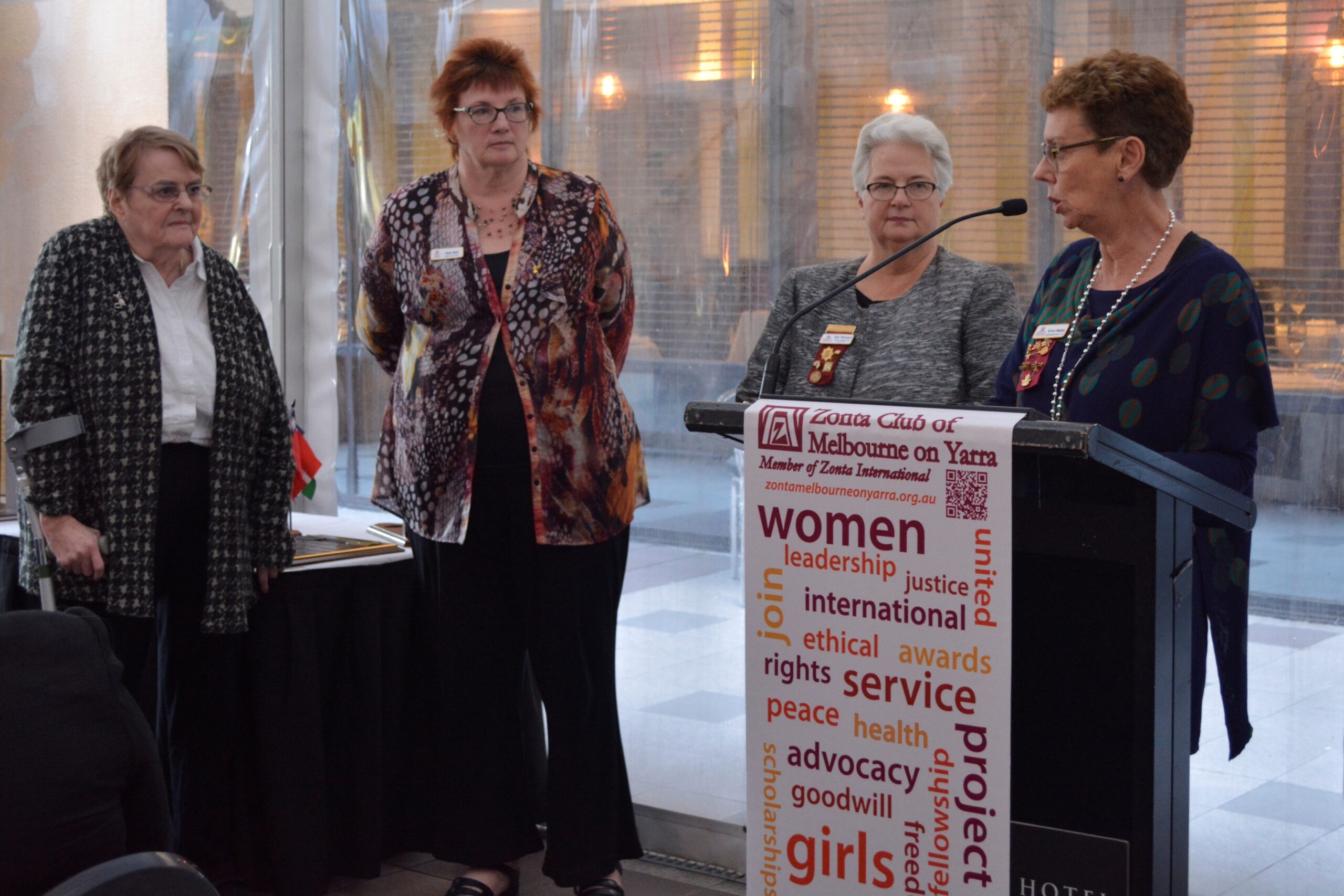 Zonta Club of Melbourne on Yarra members presenting service certificates beside the club banner